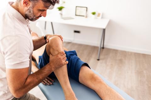 Provider helping with a patient's knee